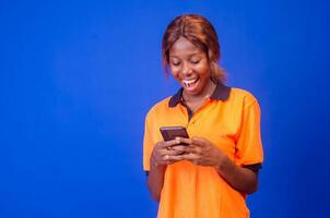 young black woman using her phone looking amazed photo