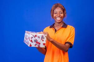 beautiful african delivery worker holding a parcel photo