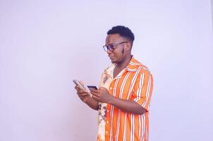 excited african man excited smiling as he makes payment with his card photo