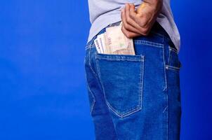 african man puts some money into her back pocket photo