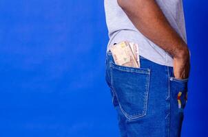 african man puts some money into her back pocket photo