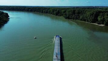 Aerial backwards view of cargo ship on Danube river in Slovakia video