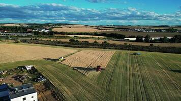 Aerial view of harvesters at work in field in August video