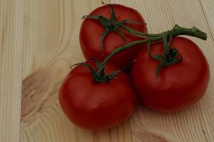 Ripe Tomatoes On A Wooden Planks Table Detailed photo