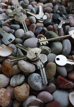 Different keys on rings and separately on colored stones and seashells photo