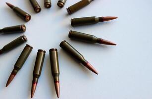 Part of an even circle of unitary cartridges laid out on a white background photo