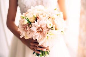 Beautiful wedding bouquet in hands of bride, close-up photo