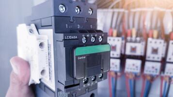 Replacement of the magnetic contactor set in the machine control panel, the concept of repairing electrical controls on machines by replacing parts. photo