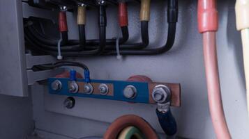 Neutral cable point with copper busbar and  connection bolt tightening. photo