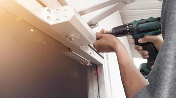 The man installing Magnetic lock system on the door for control of security system.And Installing automatic door closed with shiny light. photo