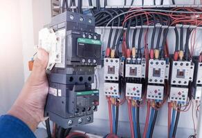Replacement of the magnetic contactor set in the machine control panel, the concept of repairing electrical controls on machines by replacing parts. photo