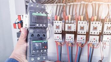 Replacement of the magnetic contactor set in the machine control panel, the concept of repairing electrical controls on machines by replacing parts. photo