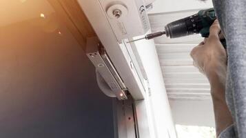 The man installing Magnetic lock system on the door for control of security system.And Installing automatic door closed with shiny light. photo