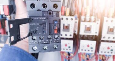 Replacement of the magnetic contactor set in the machine control panel, the concept of repairing electrical controls on machines by replacing parts. photo