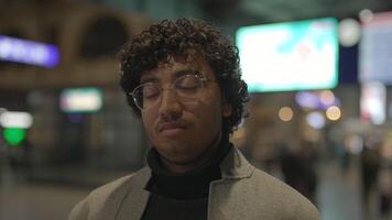 Lifestyle Portrait Of Young Man With Black Curly Hair Inside Train Station video