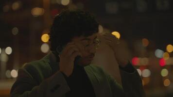 Young Man With Black Curly Hair Waiting Lonely at Train Station at Night video