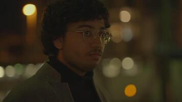 Young Man With Black Curly Hair Waiting Lonely at Train Station at Night video