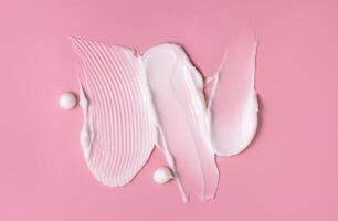 Cosmetic smear of cream texture on a pink background. Skin care. photo