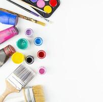 Watercolor paints and brushes for painting on a white table. Flat lay. Copy space. photo