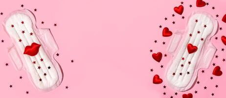 Sanitary pads in red sequins on a pink background. The concept of female menstruation. Feminine hygiene products. Banner. Copy space. photo