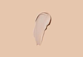 Cosmetic smear of cream texture on a beige background. Skin care. photo