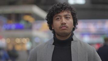 Lifestyle Portrait Of Young Man With Black Curly Hair Inside Train Station video