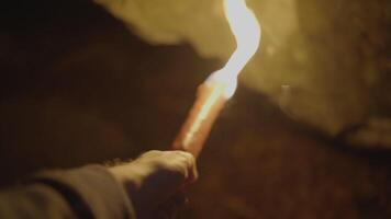 Person Holding Flaming Burning Torch Light In Stone Cave Forest At Night video