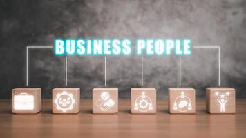 Business people concept, Wooden block on desk with business people icon on virtual screen. photo