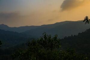 Breathtaking summer sunrise view  over the mountains with beautiful lake, kerala nature scenery image for travel and tourism concept photo