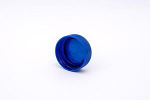 Blue plastic bottle cap isolated on white striped background, high photo quality.