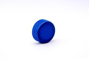 Blue plastic bottle cap isolated on white striped background, high photo quality.