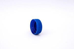 Blue plastic bottle cap isolated on white striped background, high photo quality.