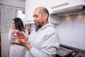 Couple preparing the dough to make cookies at home. photo