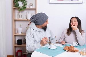 Couple enjoy cookies prepared by themselves at home. photo