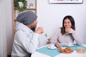 Couple enjoy cookies prepared by themselves at home. photo