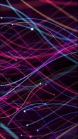 Vertical video - vibrant multi-colored glowing, flowing colorful particles and motion trails. HD and looping abstract motion background animation.