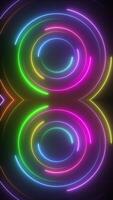 Vertical video - vibrant glowing neon disco circles retro background. Colorful spinning concentric neon circles. Full HD motion background animation.