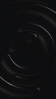 Vertical video - minimalist shiny black plastic circles abstract motion background.