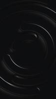 Vertical video - minimalist shiny black plastic circles abstract motion background.