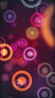 Vertical video - colorful vibrant bokeh circles abstract motion background animation.