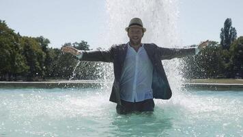 Happy Young Man Dancing in Water Fountain in Summer Time video