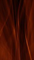Vertical video - atmospheric background with fast moving waves of glowing golden light. Full HD and looping abstract background animation.