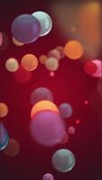 Vertical video - gently moving vibrant multi-colored shiny bokeh bubbles. Looping full HD abstract motion background animation.