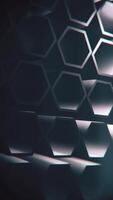 Vertical video - dark abstract geometric background with a pattern of rotating extruded hexagon shapes. Full HD and looping motion background animation.