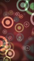 Vertical video - colorful vibrant bokeh circles abstract motion background animation.