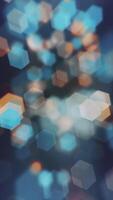 Vertical video - abstract bokeh background animation with gently flickering defocused warm blue and amber light hexagons. This elegant motion background is full HD and a seamless loop.