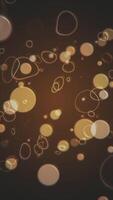 Vertical Video - abstract retro bokeh background with brown and beige plastic effect spheres and ring squiggles. This vintage liquid motion style background animation is full HD and a seamless loop.