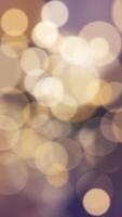 Vertical video - abstract bokeh background animation with gently flickering defocused warm golden bokeh light spheres. This elegant motion background is full HD and a seamless loop.