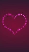 Vertical video - cute magical pink and red neon heart shape with flashing glow spheres and swirling, glittering particles. This romantic Valentine's Day background is full HD and a seamless loop.