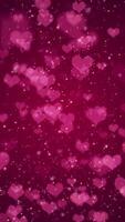 Vertical video - cute pink hearts, shiny stars and glowing glittering particles on dark red gradient background. This shiny romantic Valentine's Day background is full HD and a seamless loop.